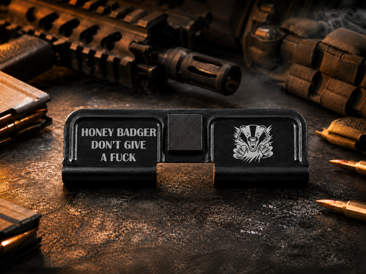 Honey Badger Don't Give A Fuck AR-15 Dust Cover showing the engraved artwork on both sides of the black steel cover.