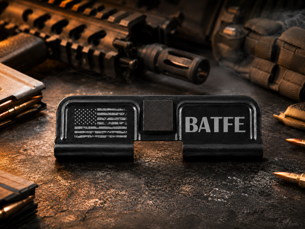 BATFE AR-15 Dust Cover showing the engraved artwork on both sides of the black steel cover.