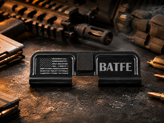 BATFE AR-15 Dust Cover showing the engraved artwork on both sides of the black steel cover.