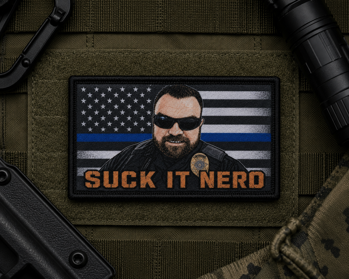 Suck It Nerd Patch design with a black border on tactical gear.