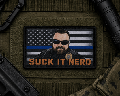 Suck It Nerd Patch design with a black border on tactical gear.