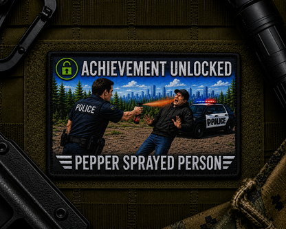 Pepper Spray Achievement Patch design with a black border on tactical gear.