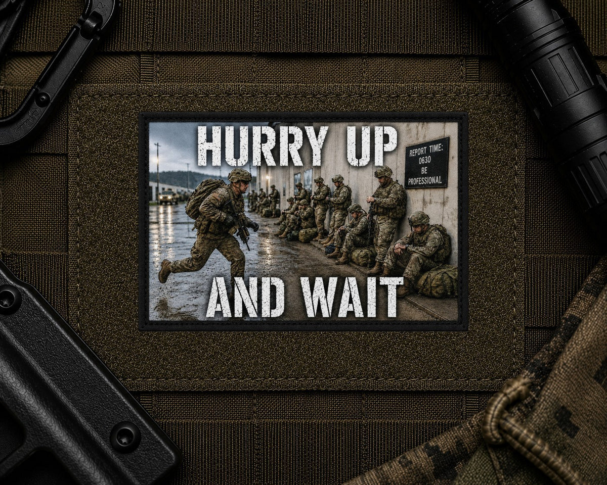Hurry Up And Wait Patch design with a black border on tactical gear.