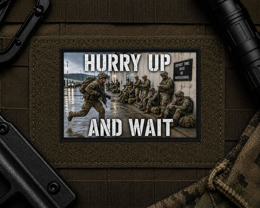 Hurry Up And Wait Patch design with a black border on tactical gear.