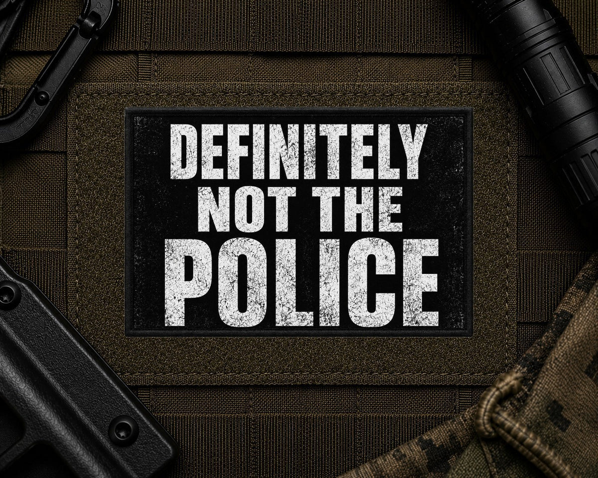 Definitely Not The Police Patch design with a black border on tactical gear.