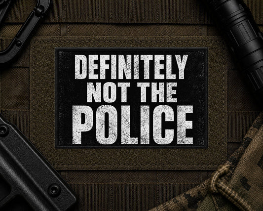Definitely Not The Police Patch design with a black border on tactical gear.