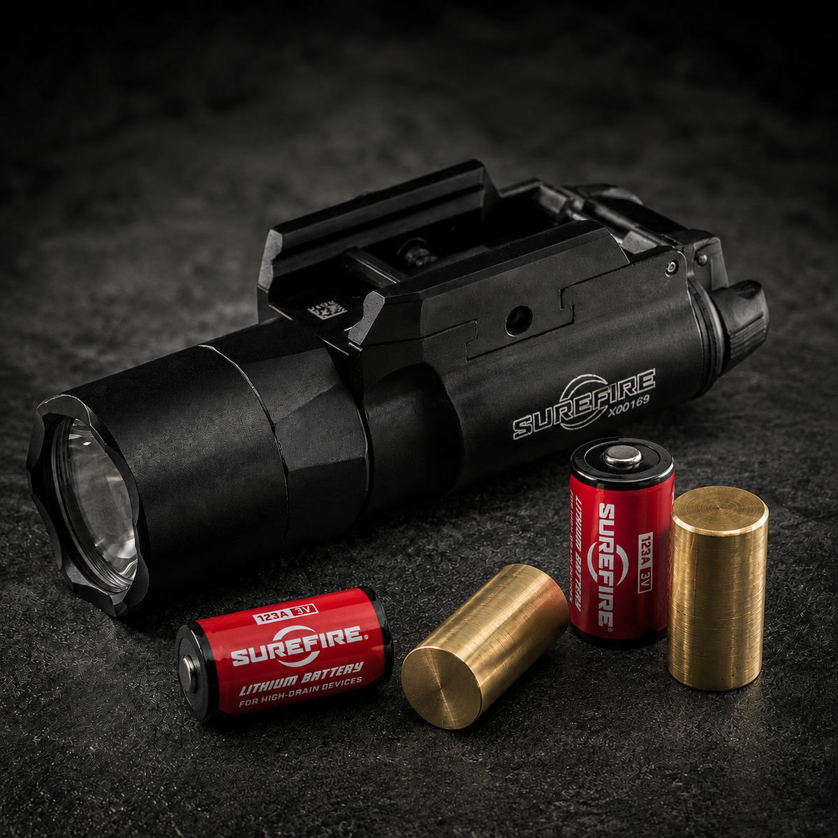 Pistol light shown beside CR123A batteries and brass replacement weights.